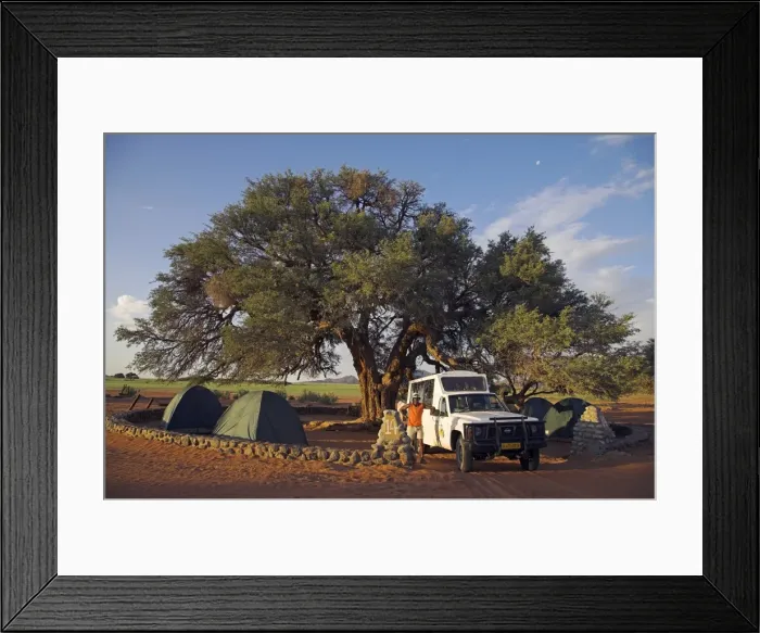 Framed Print : A safari guide stands in front of his Land Cruiser Framed Print : A safari guide stands in front of his Land Cruiser