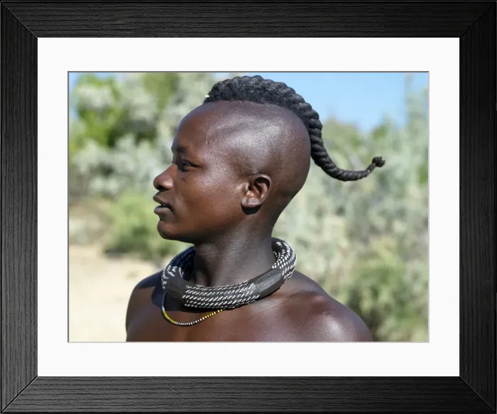 Framed Print : A Himba youth with his hair styled in a long plait, known as ondatu Framed Print : A Himba youth with his hair styled in a long plait, known as ondatu