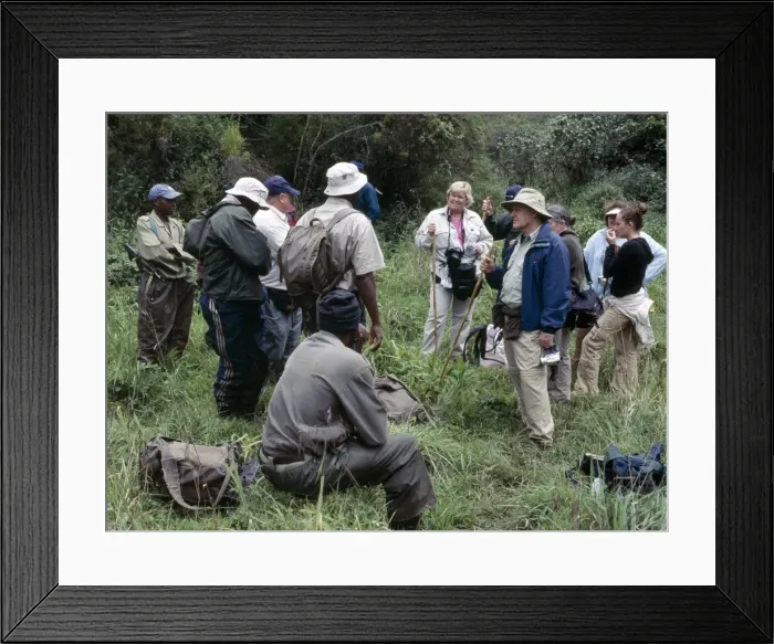 Framed Print : A group of tourists is briefed by parks staff of