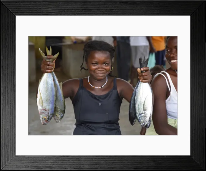 Framed Print : A Sao Tomense woman shows us what fish she is selling