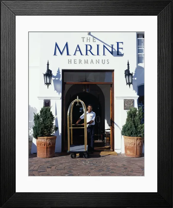 Framed Print : A bellboy pushes the luggage trolley through the Hotel entrance Framed Print : A bellboy pushes the luggage trolley through the Hotel entrance