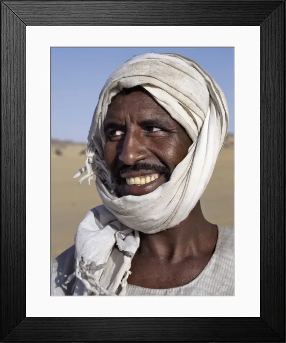 Framed Print : A Nubian man wearing a white turban smiles broadly at his friend Framed Print : A Nubian man wearing a white turban smiles broadly at his friend