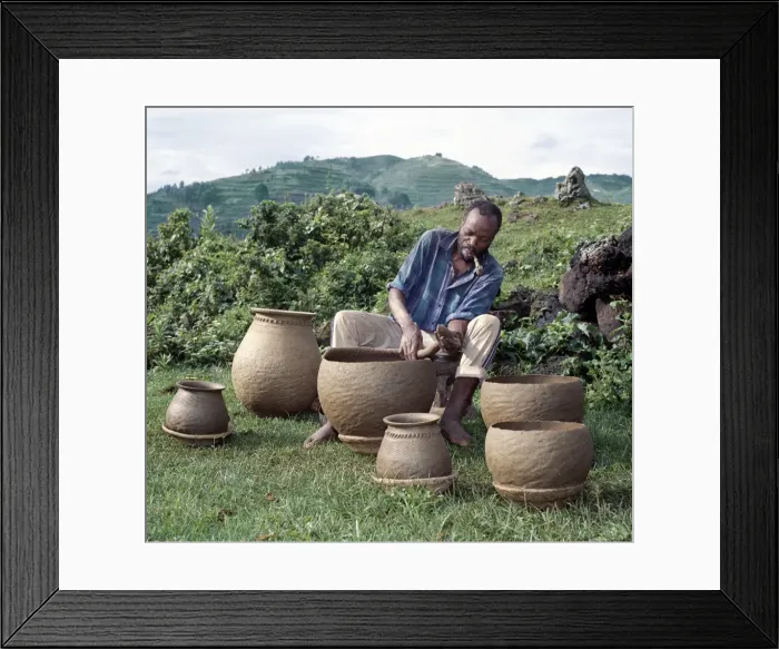 Framed Print : A potter fashions cooking pots by the coil method Framed Print : A potter fashions cooking pots by the coil method