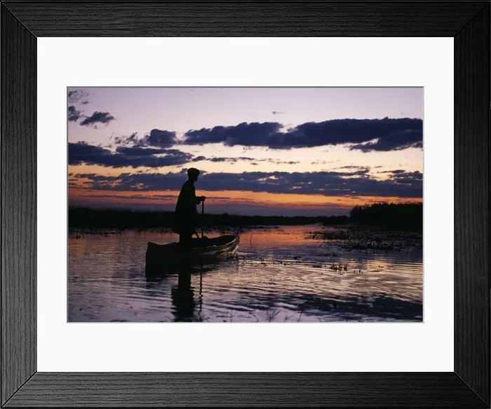 Framed Print : Zambia Game scout poling mokorro along Lukulu River at sunset