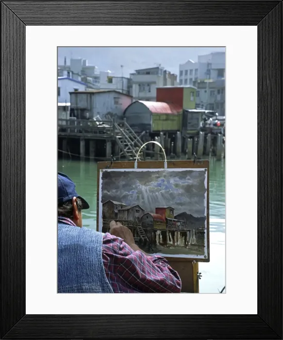 Framed Print : An artist at work painting the stilt house village Framed Print : An artist at work painting the stilt house village