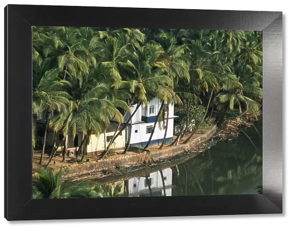 A house looks out on a palm-fringed lagoon