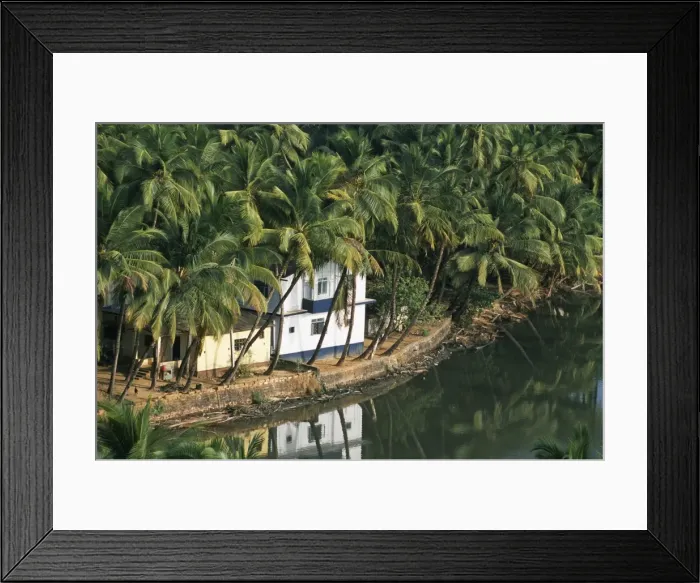 Framed Print : A house looks out on a palm-fringed lagoon Framed Print : A house looks out on a palm-fringed lagoon