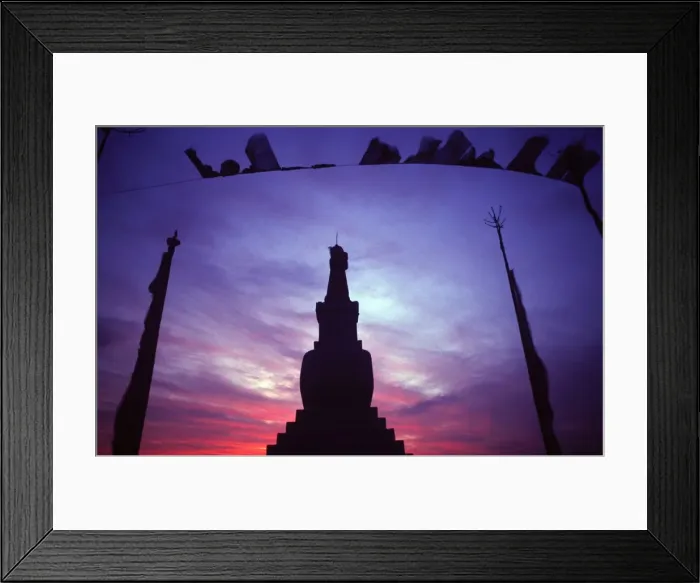 Framed Print : Tibetan Buddhist stupa and prayer flags silhouetted against sunset Framed Print : Tibetan Buddhist stupa and prayer flags silhouetted against sunset