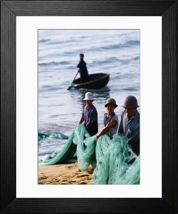 Framed Print : Carrying fishing nets up the beach after the days work Framed Print : Carrying fishing nets up the beach after the days work