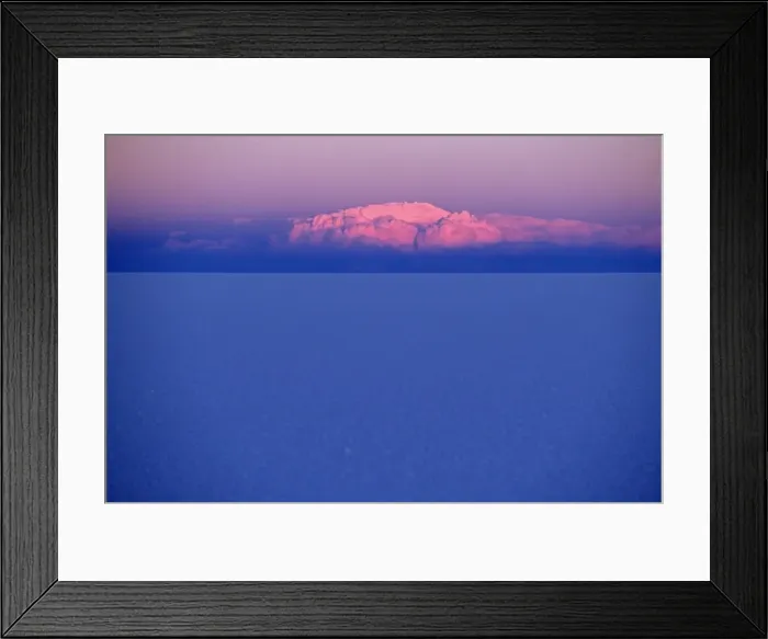 Framed Print : At sunset a cloud is painted pink by the last rays Framed Print : At sunset a cloud is painted pink by the last rays