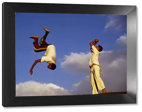 Two boys practice Capoeira, the Brazilian martial art