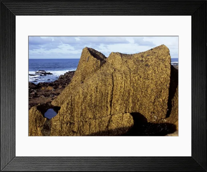 Framed Print : The supine form of a finely chiselled moai or stone head Framed Print : The supine form of a finely chiselled moai or stone head