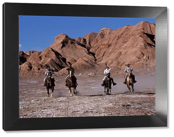 Tourists horse riding amongst the wind-eroded peaks