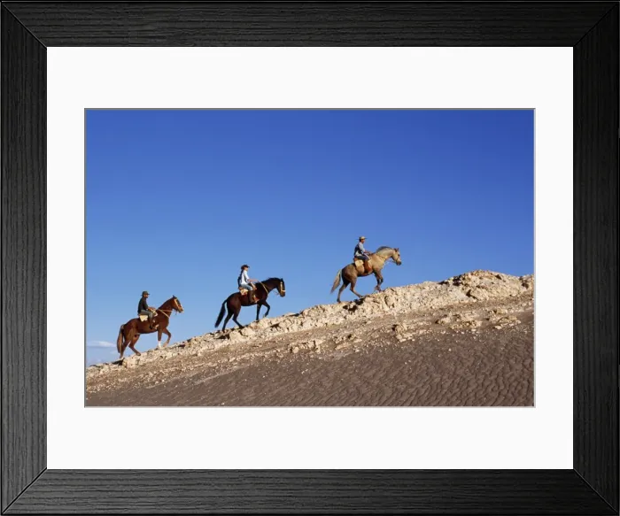 Framed Print : Horse riding along a ridge amongst the wind-eroded Framed Print : Horse riding along a ridge amongst the wind-eroded