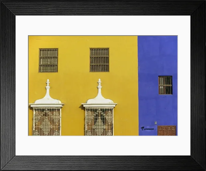 Framed Print : Wrought iron grillwork and pastel shades of a colonial Framed Print : Wrought iron grillwork and pastel shades of a colonial