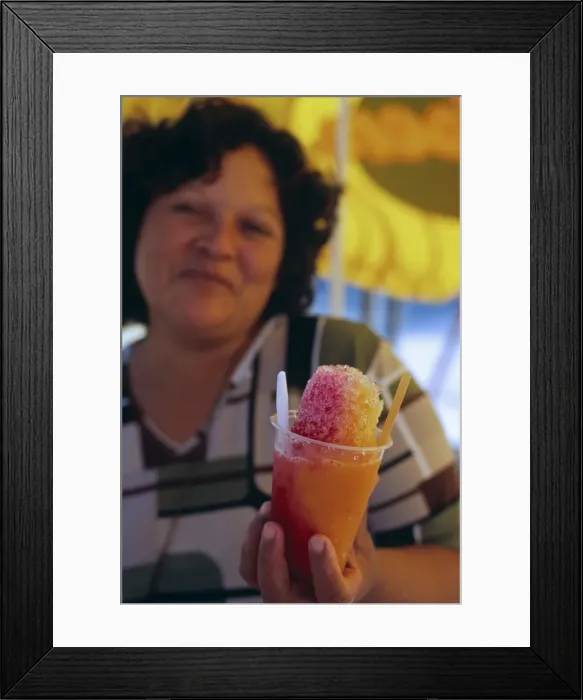 Framed Print : A vendor serves up a shaved ice treat on the beach at Mancora