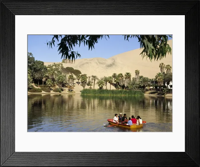 Framed Print : A family rows out onto the oasis lagoon of Huacachina Framed Print : A family rows out onto the oasis lagoon of Huacachina