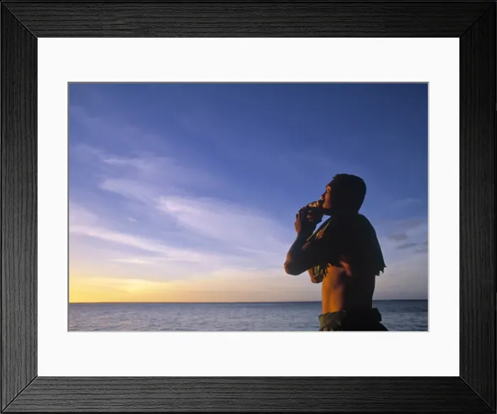 Framed Print : Man blowing into a seashell Framed Print : Man blowing into a seashell