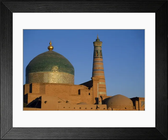 Framed Print : The minaret and tiled dome of a mosque rise above Framed Print : The minaret and tiled dome of a mosque rise above