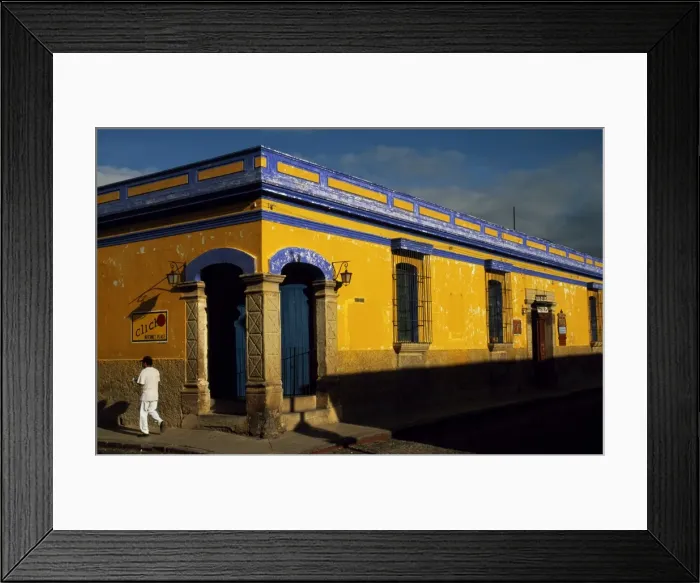 Framed Print : A man walks along the a street in downtown Antigua