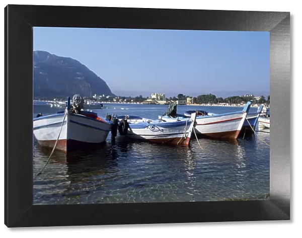 Fishing boats in the crystal clear waters of the seaside resort Modello