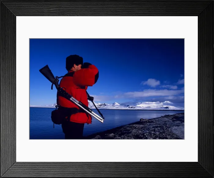 Framed Print : Armed guide checking for polar bears prior to land excursion Framed Print : Armed guide checking for polar bears prior to land excursion