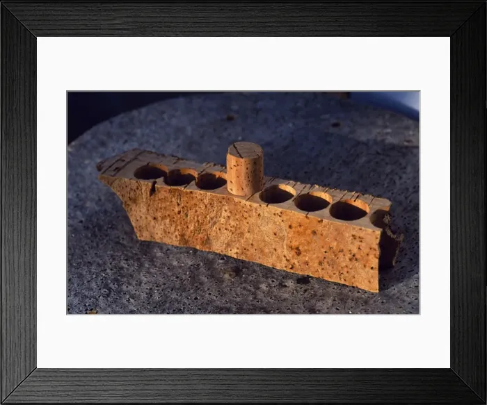 Framed Print : Block of cork showing how corks for bottles are drilled Framed Print : Block of cork showing how corks for bottles are drilled