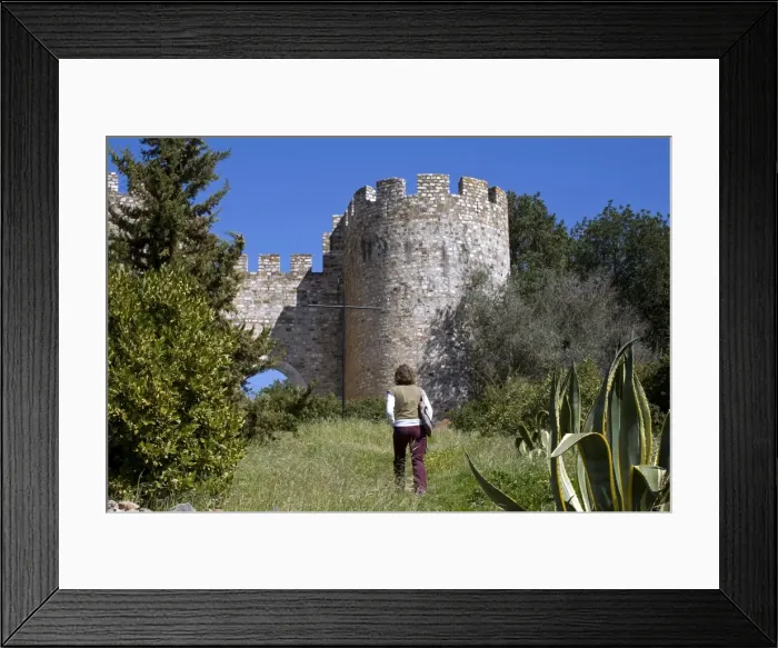 Framed Print : A young tourist takes a path up to the castle in Framed Print : A young tourist takes a path up to the castle in