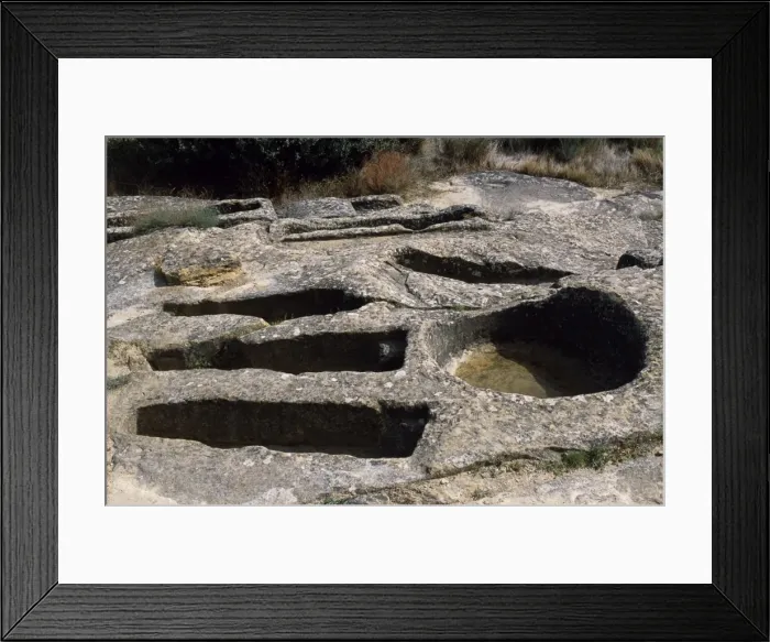 Framed Print : Ancient graves carved out of the solid rock lie alongside Framed Print : Ancient graves carved out of the solid rock lie alongside