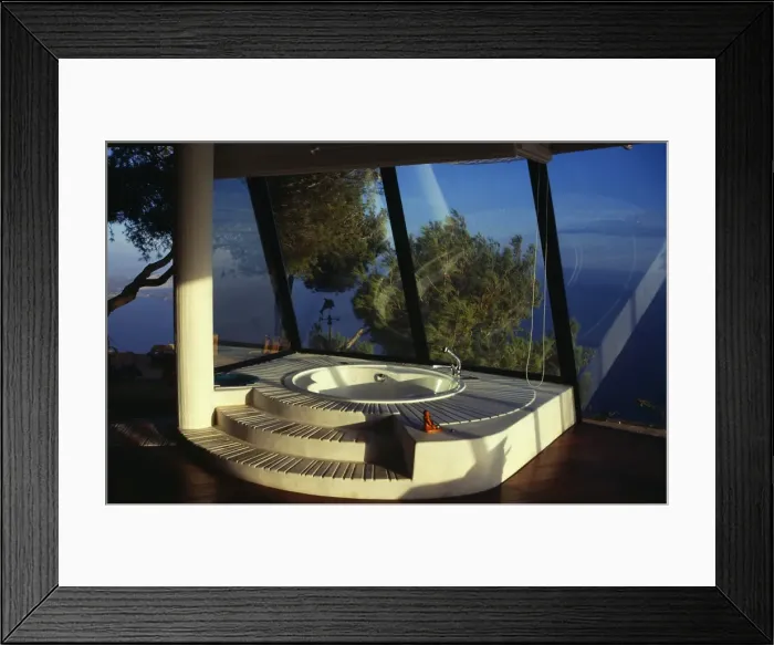 Framed Print : Sunken bath in sunlit room with panoramic glass windows Framed Print : Sunken bath in sunlit room with panoramic glass windows