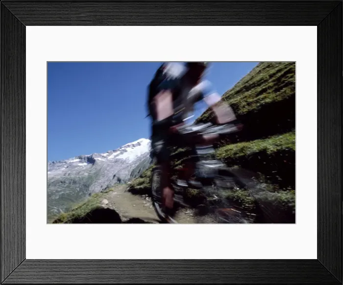 Framed Print : A cyclist mountain biking on Mont Blanc