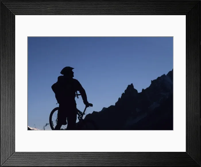 Framed Print : A cyclist on a mountain bike tour of Mont Blanc