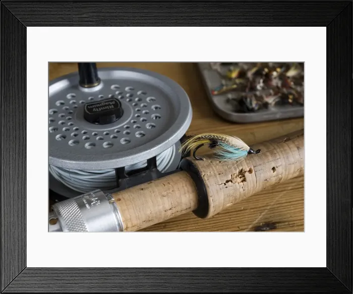 Framed Print : UK. A salmon fly stuck into the cork handle of a fly fishing rod Framed Print : UK. A salmon fly stuck into the cork handle of a fly fishing rod
