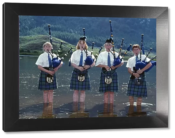 Young pipers cooling down in the loch during a break