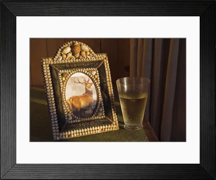 Framed Print : A glass of whisky rests beside a shell encrusted picture Framed Print : A glass of whisky rests beside a shell encrusted picture