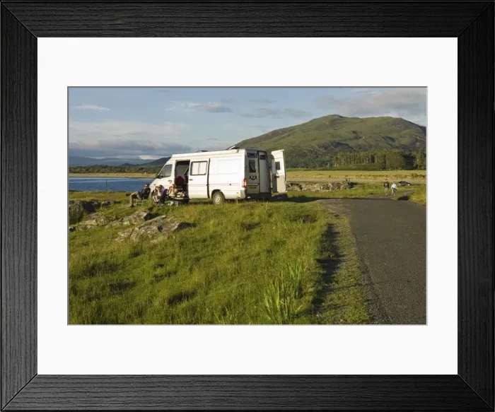 Framed Print : A family on a camping holiday sit outside their campervan