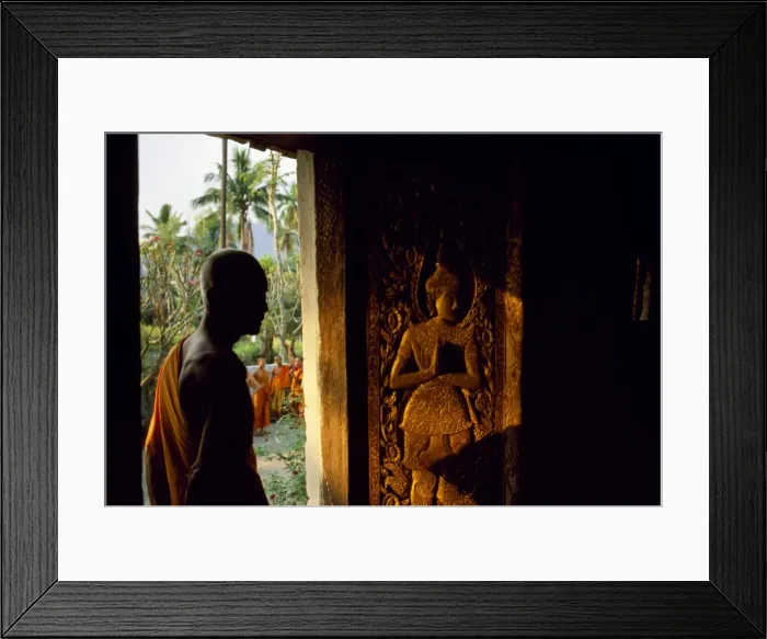 Framed Print : Monk standing by the door of Wat Mai Suwannaphumaham Framed Print : Monk standing by the door of Wat Mai Suwannaphumaham