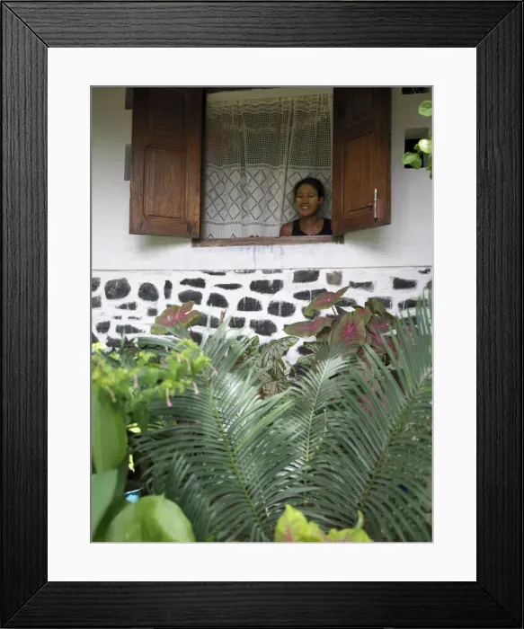 Framed Print : A Malagasy woman admires her garden from the window Framed Print : A Malagasy woman admires her garden from the window
