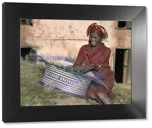 A Malagasy woman weaves a basket from raffia palm