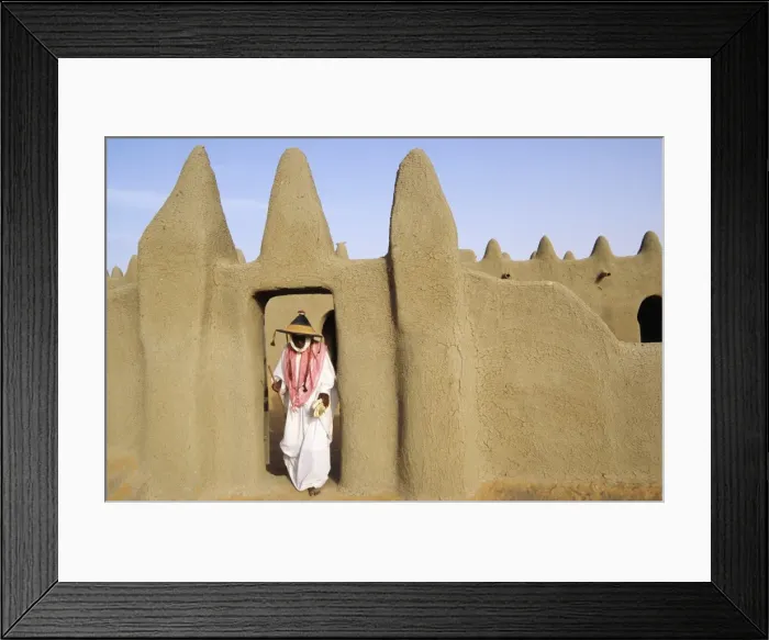 Framed Print : MALI, Djenne A pilgrim emerges from prayers at a traditional Framed Print : MALI, Djenne A pilgrim emerges from prayers at a traditional