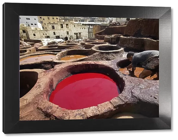 A man working in the tanneries in Old Fez, Morocco