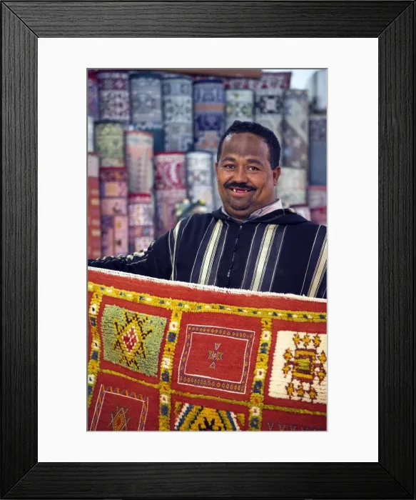 Framed Print : A carpet salesman displays his wares in the souq of Marrakesh Framed Print : A carpet salesman displays his wares in the souq of Marrakesh