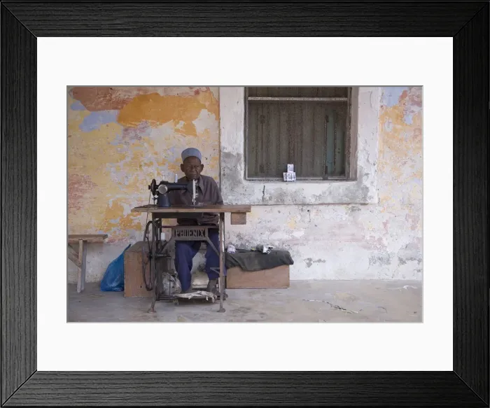 Framed Print : A man works his sewing machine on Ibo Island Framed Print : A man works his sewing machine on Ibo Island