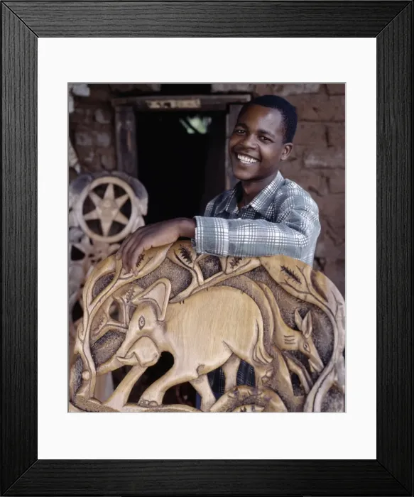 Framed Print : A wood carver puts the finishing touches to a Chiefs chair Framed Print : A wood carver puts the finishing touches to a Chiefs chair