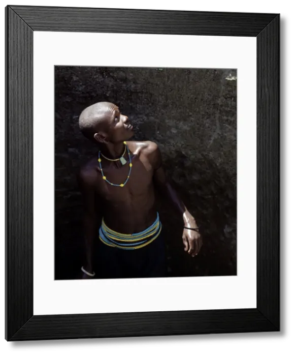 Framed Print : Young Datoga man in a well Framed Print : Young Datoga man in a well