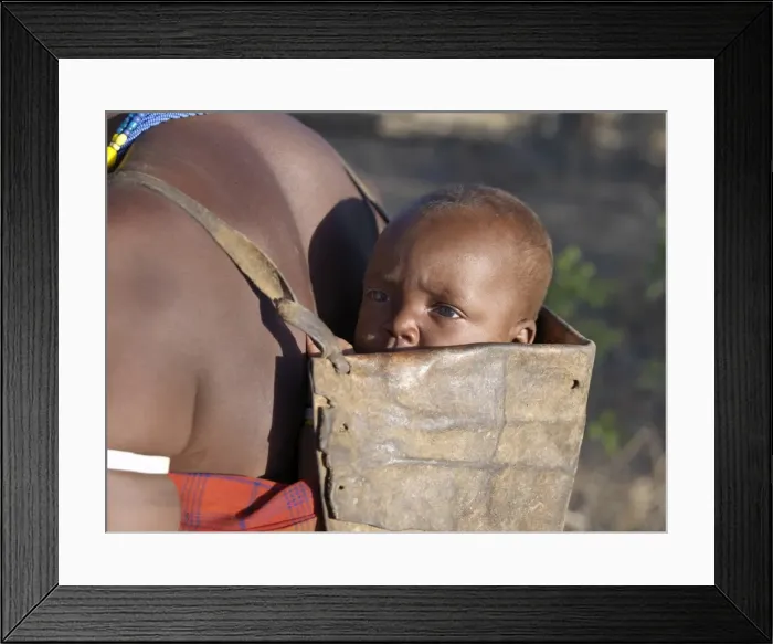 Framed Print : Datoga baby on his mothers back Framed Print : Datoga baby on his mothers back