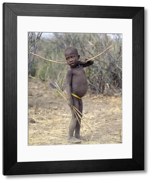 Framed Print : A Hadza boy carrying a bow and arrows Framed Print : A Hadza boy carrying a bow and arrows
