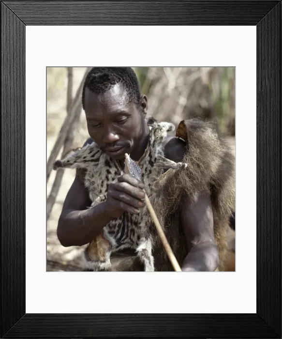 Framed Print : A Hadza hunter checks the straightness of a new arrow shaft Framed Print : A Hadza hunter checks the straightness of a new arrow shaft