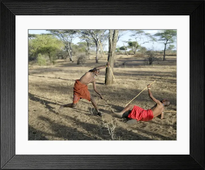 Framed Print : Two Datoga men participate in a mock stick fight Framed Print : Two Datoga men participate in a mock stick fight