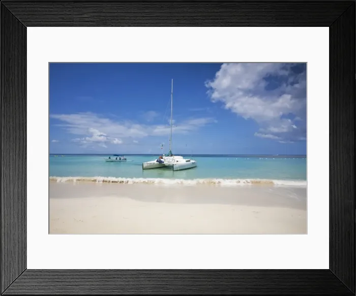 Framed Print : Honduras, Bay Islands, Roatan, West Bay, Man reading book on catamaran
